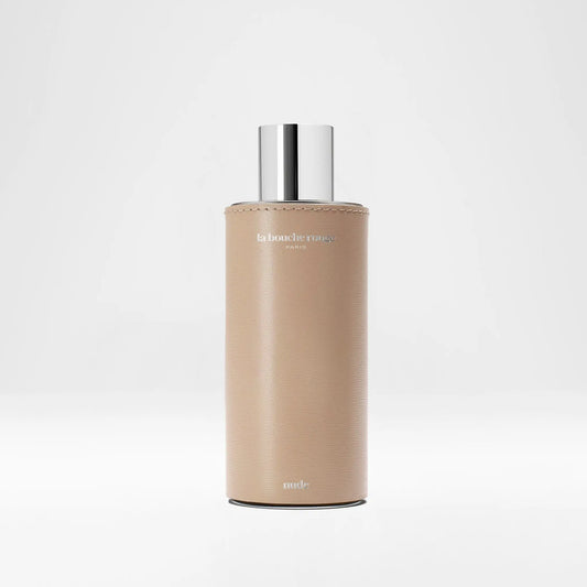 Flacon de parfum Nude, extrait de La Bouche Rouge ambretmusc, 100 ml en verre gainé de cuir beige avec capot métal et liège.