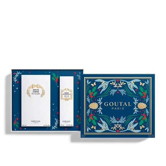 Écrin rituel Petite Chérie d'Annick Goutal dans la collection ambretmusc, avec décor bleu orné de motifs floraux et pommes de pins dorés.