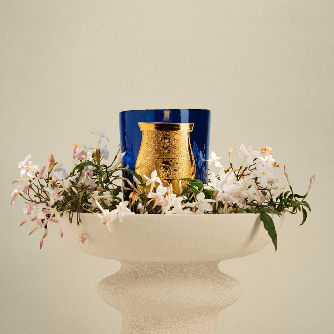 Trudon, classic scented candle Maduraï, Belles Matières Collection, on a vase surrounded by jasmine | Trudon